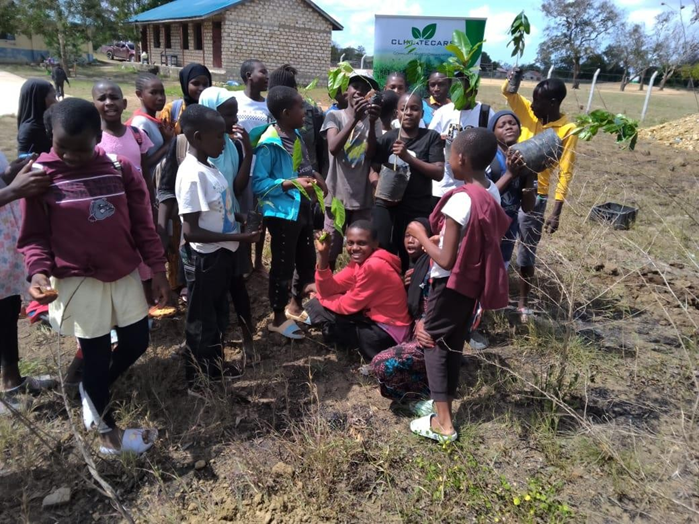 Children planting trees after successfully completed the two weeks seminar